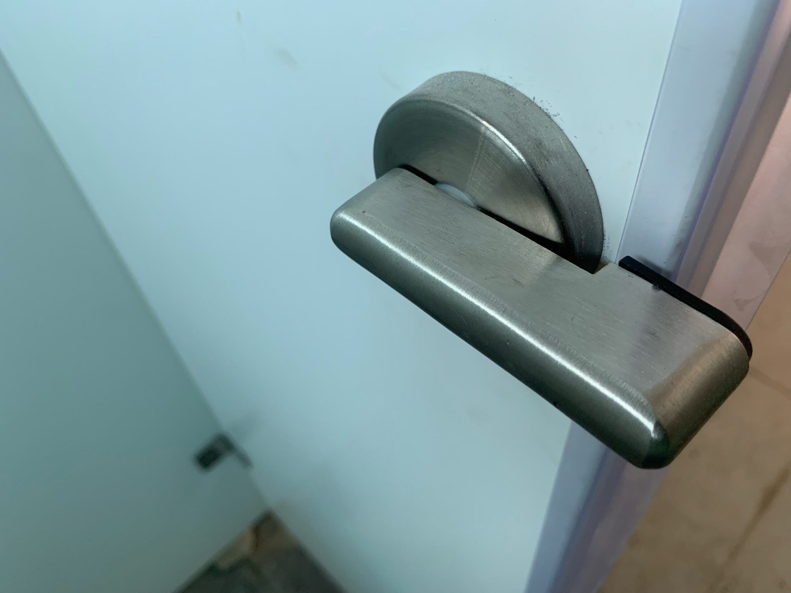 Restroom partition privacy strip solutions amplify a toilet cubicle's privacy, as illustrated in this image of a partition door, edge, and handle.